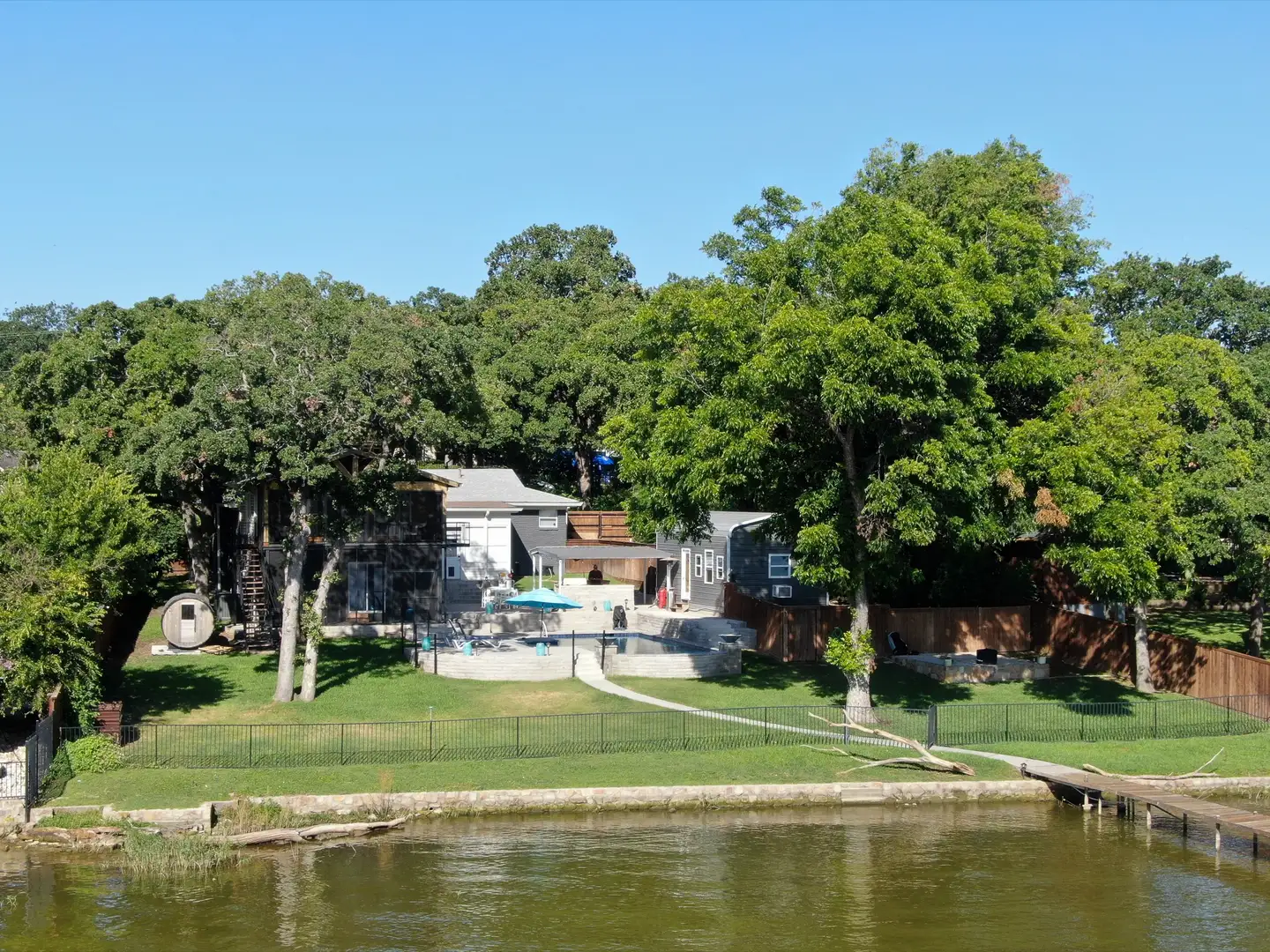 View of yard and pool from the lake